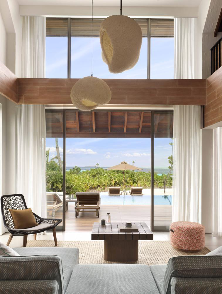 Family beach retreat living room opening onto a pool at Six Senses Kanuhura