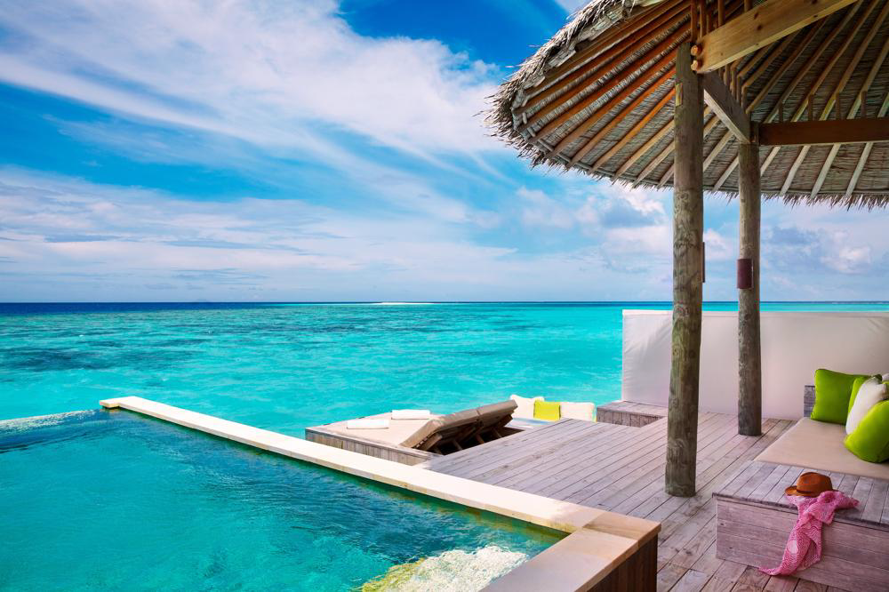 Pool deck at a Six Senses Laamu ocean water villa